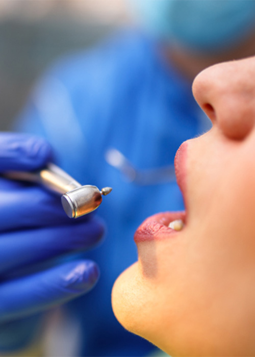 Dentist treating the teeth of a sedated patient