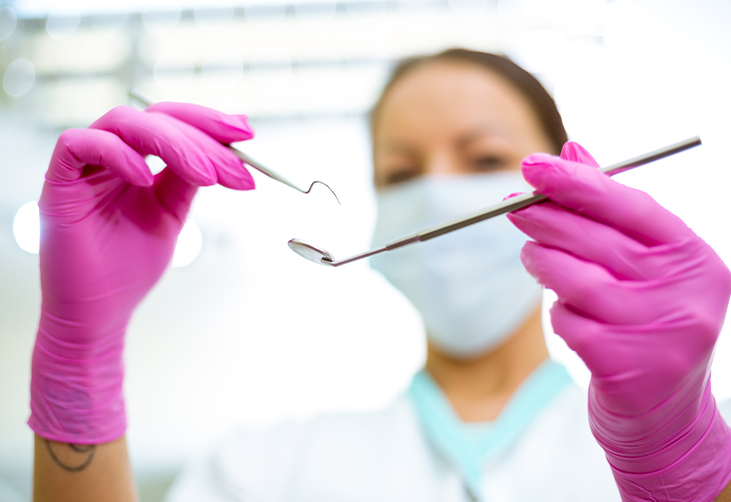Dentist inspecting her dental instruments 