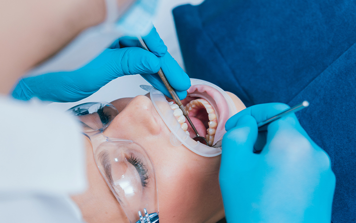 Dentist inspecting a patient's teeth