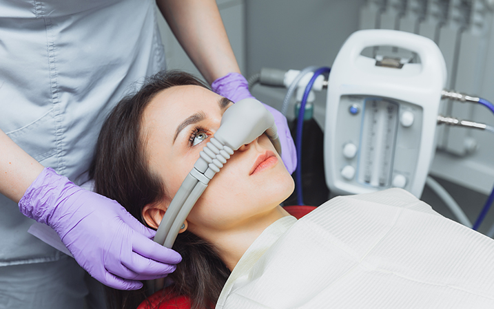 Dentist sedating a patient