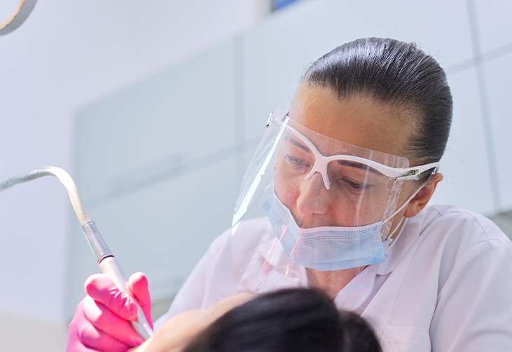 Dentist treating the teeth of a sedated patient