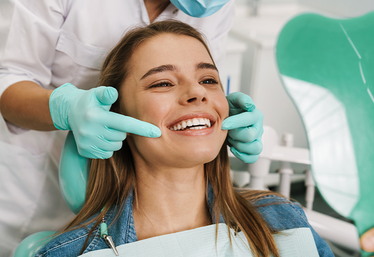 Dentist pointing to a patient's smile