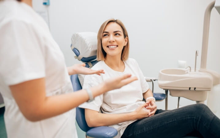 Dentist speaking with her patient