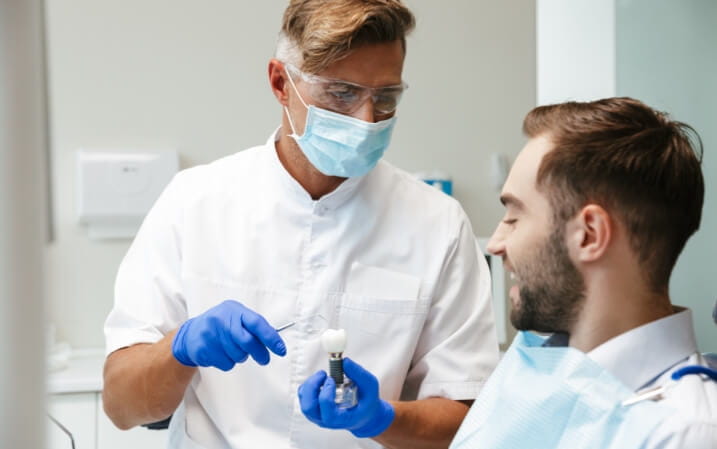 Dentist speaking with his patient