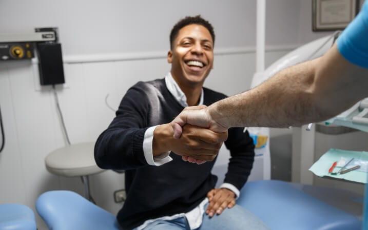 Dentist shaking hands with his patient